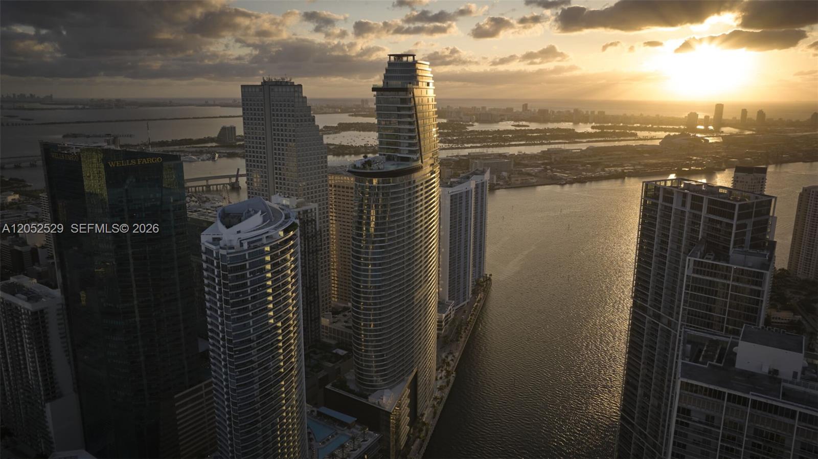 An aerial view shows skyscrapers in Miami along the water during a sunset — 300 Biscayne Boulevard Way # 1705W, Miami FL 33131, MIAMI, FL