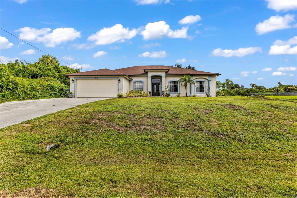 A single-story house with a beige exterior, brown roof, and a two-car garage — 2142 SNOVER AVENUE, NORTH PORT, FL