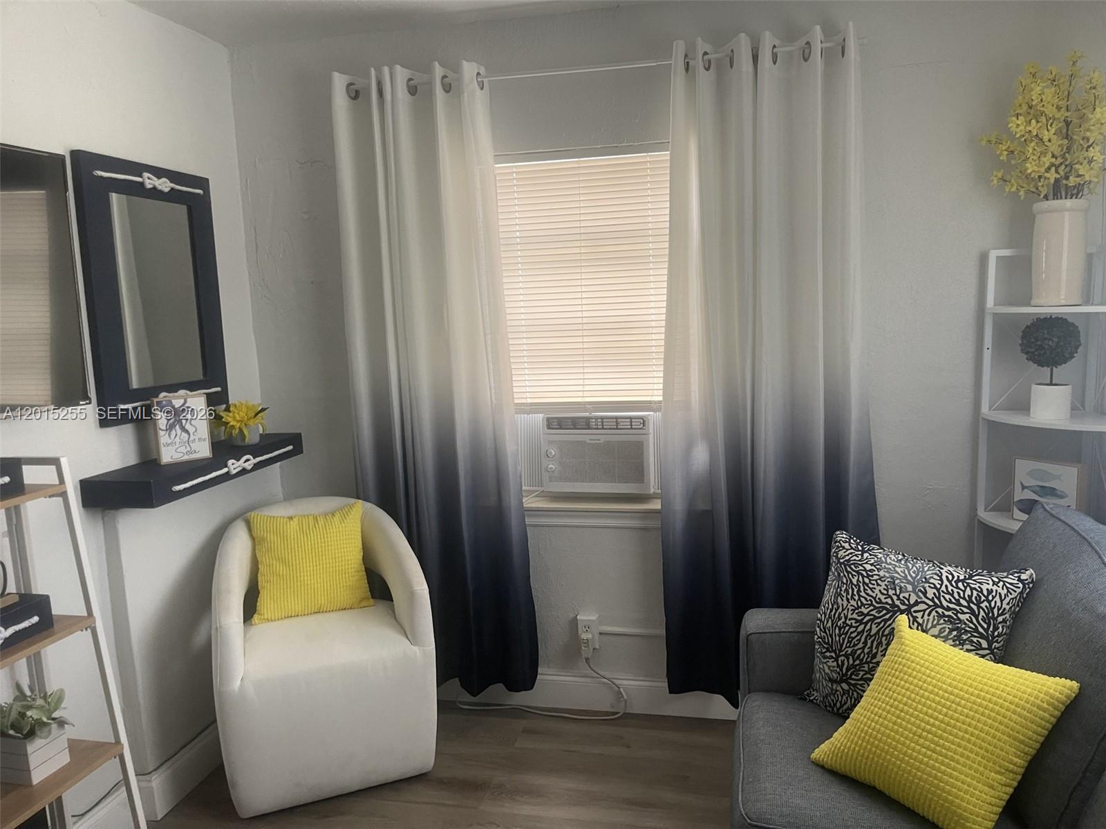 A living room features a white armchair, a gray sofa, ombre curtains, and nautical decor — 1019 NW 4th Ave, Pompano Beach FL 33060, POMPANO BEACH, FL