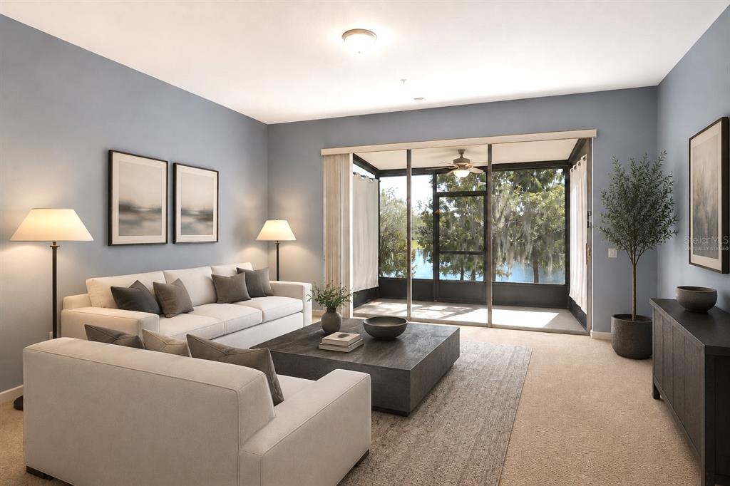 A living room with light blue walls, white sofas, a dark coffee table, and a screened-in porch — 6206 CASTELVEN DRIVE UNIT 104, ORLANDO, FL