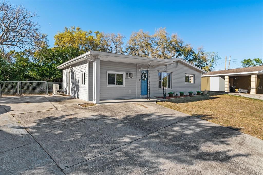 A single-story gray house with a blue front door and a concrete driveway — 4817 DRIFT TIDE DRIVE, NEW PORT RICHEY, FL