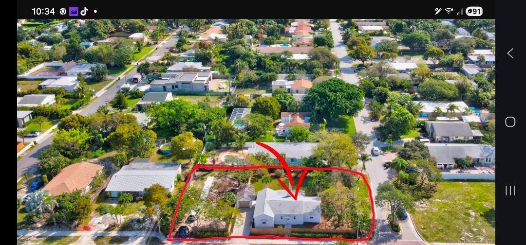 An aerial view shows a single-story house with a fenced yard in a residential neighborhood — 1303 NE 2nd Avenue, Delray Beach FL 33444, DELRAY BEACH, FL