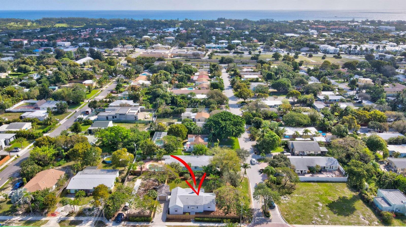 An aerial view of a single-story house with a grey roof in a residential neighborhood — 1303 NE 2nd Avenue, Delray Beach FL 33444, DELRAY BEACH, FL