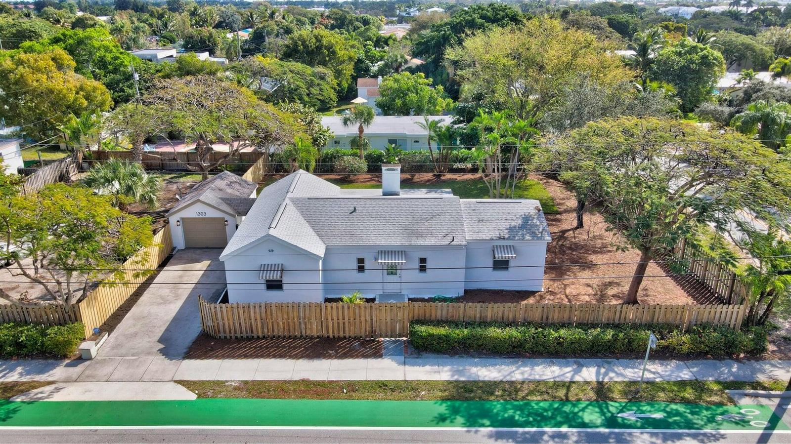 An aerial view of a single-story house with a detached garage and a wooden fence — 1303 NE 2nd Avenue, Delray Beach FL 33444, DELRAY BEACH, FL