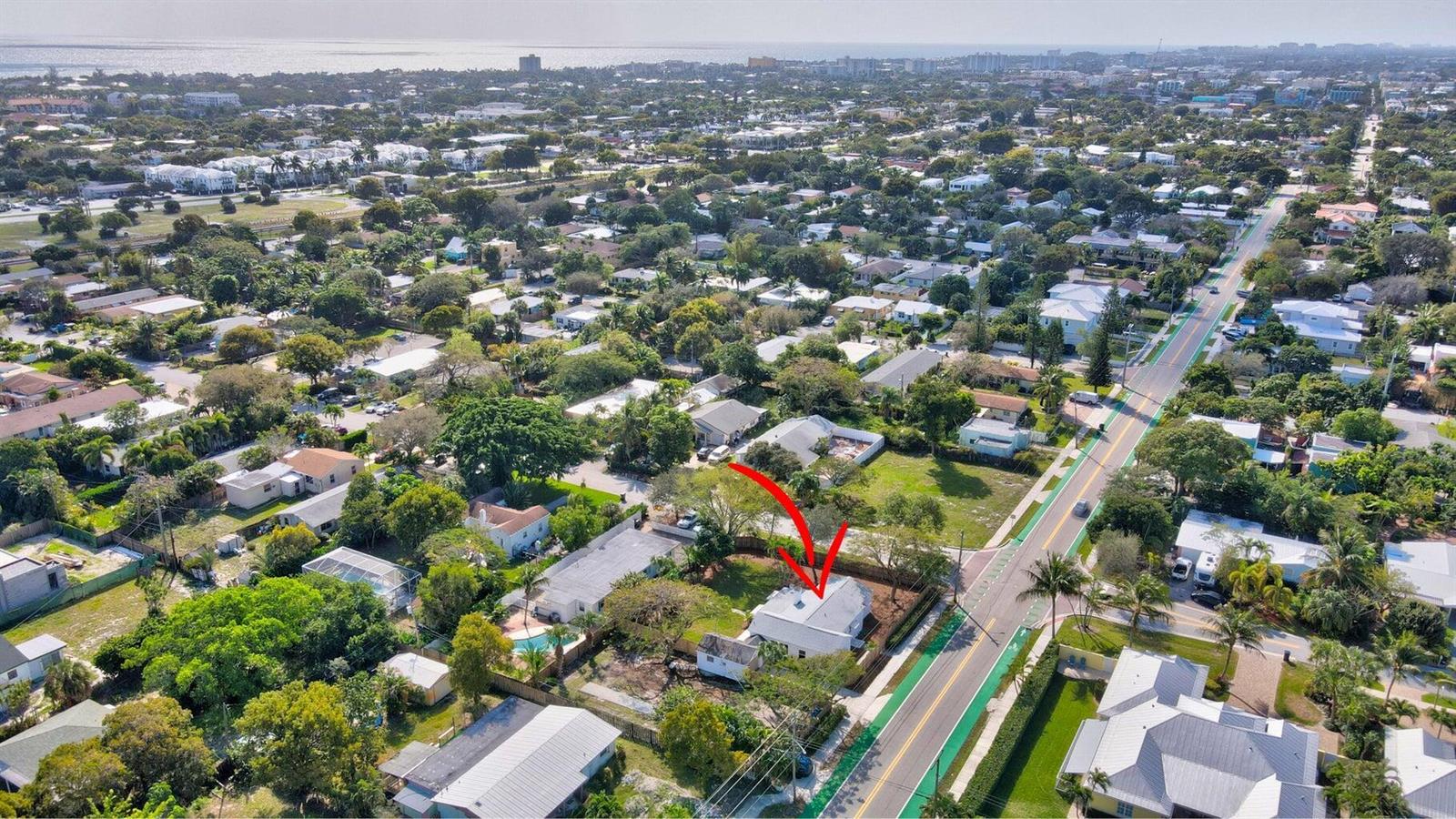 An aerial view of a residential property with a red arrow pointing to the house — 1303 NE 2nd Avenue, Delray Beach FL 33444, DELRAY BEACH, FL