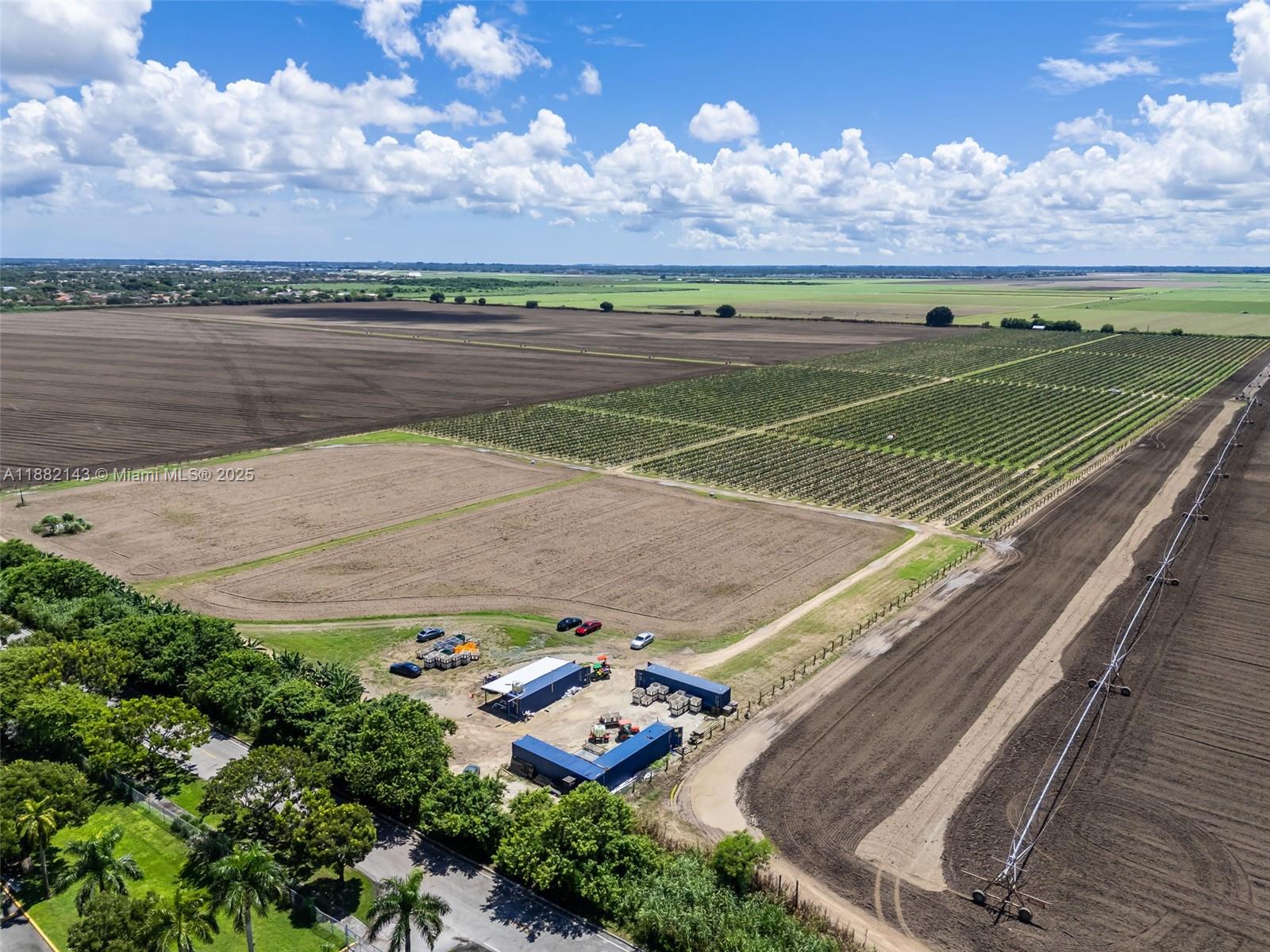An aerial view shows a large agricultural property with fields, crops, and a storage facility — SW MIAMI-DADE, Miami FL 33196, MIAMI, FL