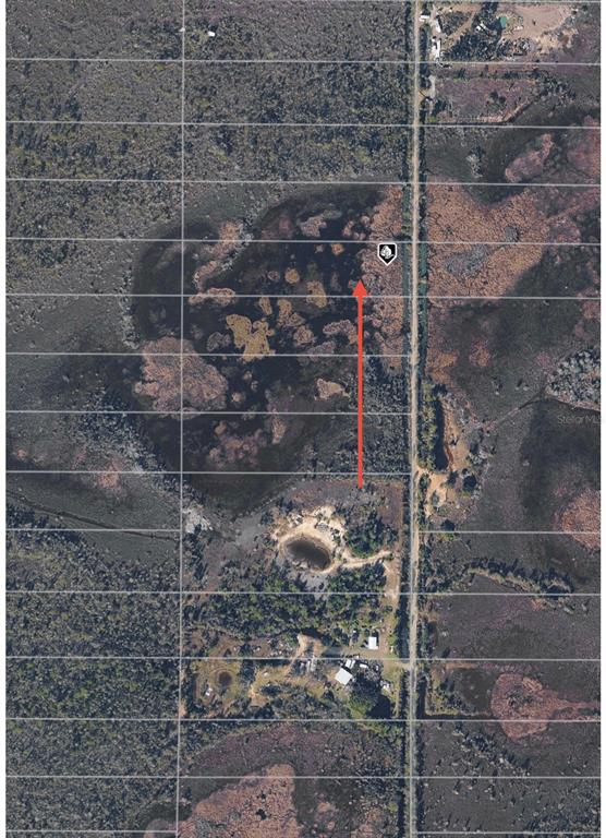 An aerial map view shows a rural property with a large wetland area and structures — 33892 OIL WELL ROAD, PUNTA GORDA, FL