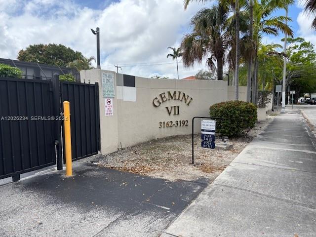 A modern kitchen features gray cabinets, stainless steel appliances, and white countertops — 3190 Bird Ave # 15, Coconut Grove FL 33133, COCONUT GROVE, FL