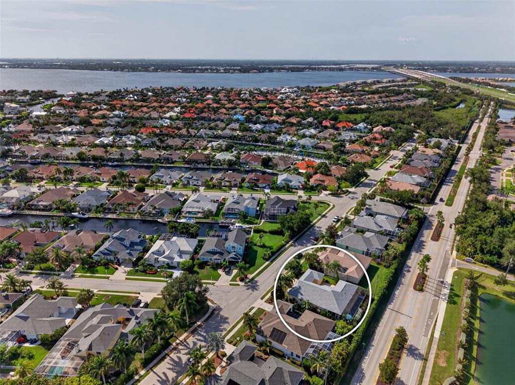 A single-story house exterior with a light-colored facade, palm trees, and a front porch — 171 AMERICAS CUP BOULEVARD, BRADENTON, FL
