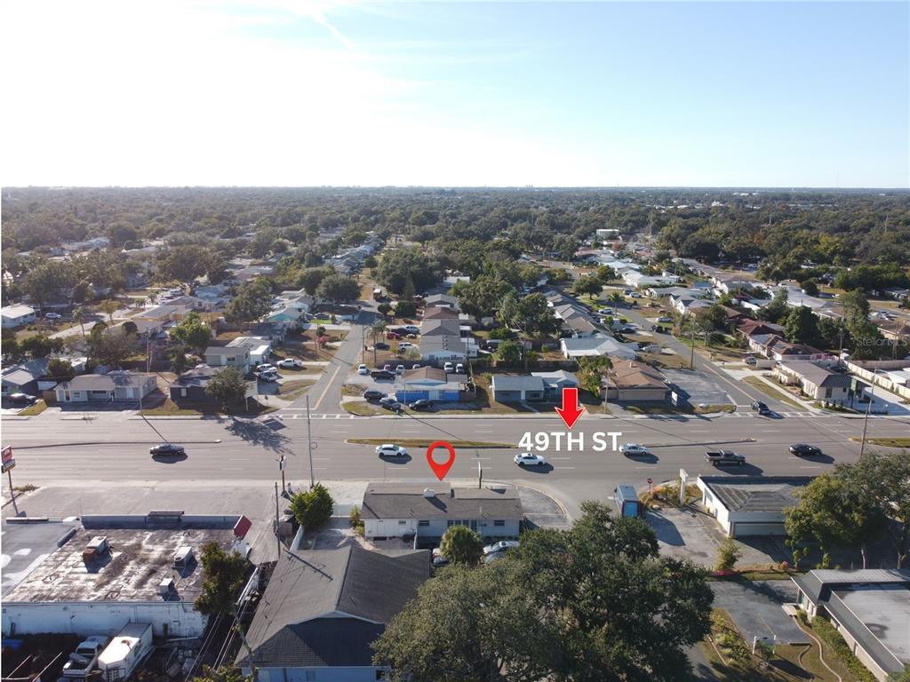 An aerial view shows a commercial building with a red location pin on a street — 4795 49TH STREET N, ST PETERSBURG, FL
