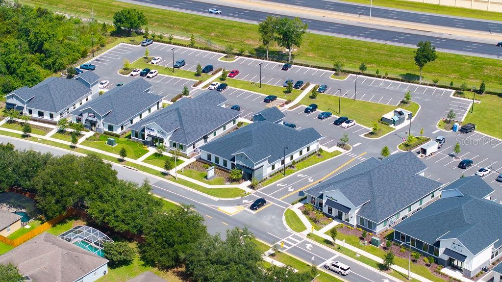 An aerial view shows several commercial office buildings with parking lots and surrounding landscaping — 12283 STONEYBROOK WEST PARKWAY UNIT B, WINTER GARDEN, FL