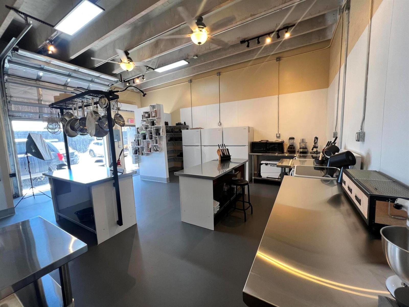 An industrial-style room features a black brick wall, gray concrete floor, and a small sink — 1211 Old Okeechobee Road, West Palm Beach FL 33401, WEST PALM BEACH, FL