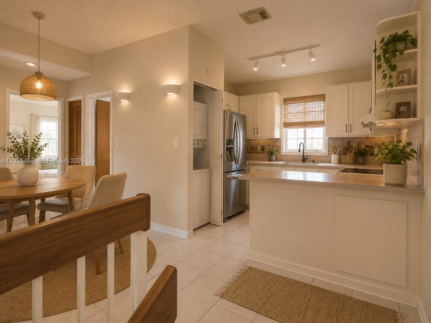 A kitchen with white cabinets, stainless steel appliances, and an adjacent dining area — 2220 W 74th St # 16, Hialeah FL 33016, HIALEAH, FL