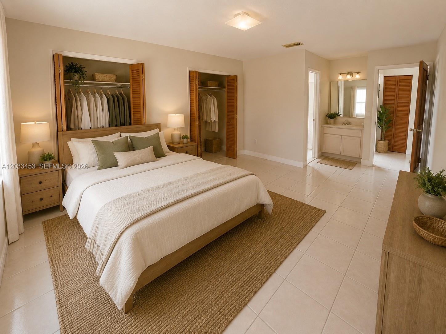 A bedroom features a bed, two closets, tile flooring, and an attached bathroom vanity area — 2220 W 74th St # 16, Hialeah FL 33016, HIALEAH, FL