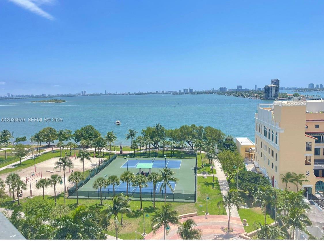 An elevated view of a tennis court, park, and bay with a city skyline — 1750 N Bayshore Dr # 3010, Miami FL 33132, MIAMI, FL