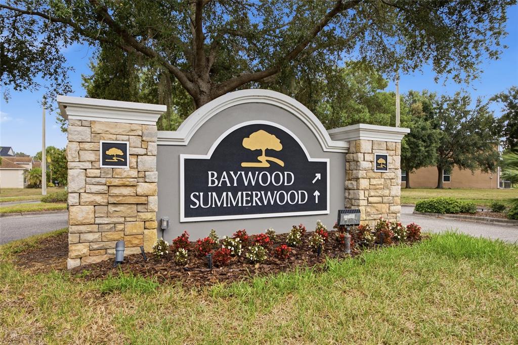 A stone and stucco monument sign marks the entrance to the Baywood and Summerwood communities — 6924 TOWERING SPRUCE DRIVE, RIVERVIEW, FL
