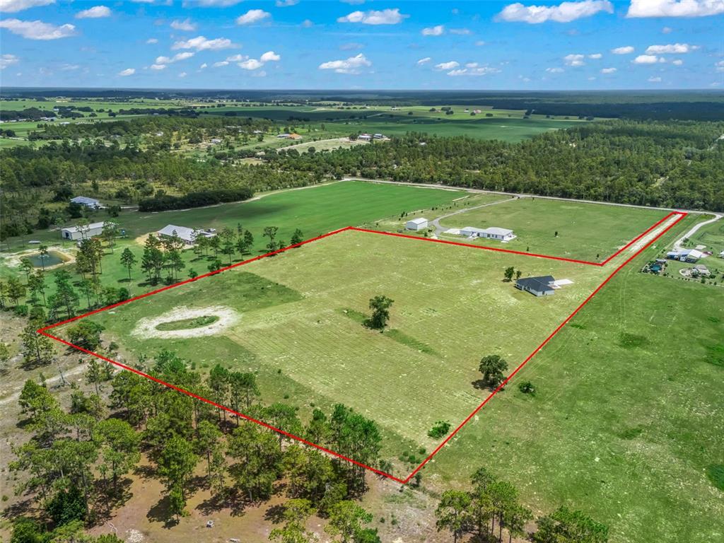 An aerial view shows a large, rectangular plot of land outlined in red with a house — 14461 SE 80TH STREET, MORRISTON, FL