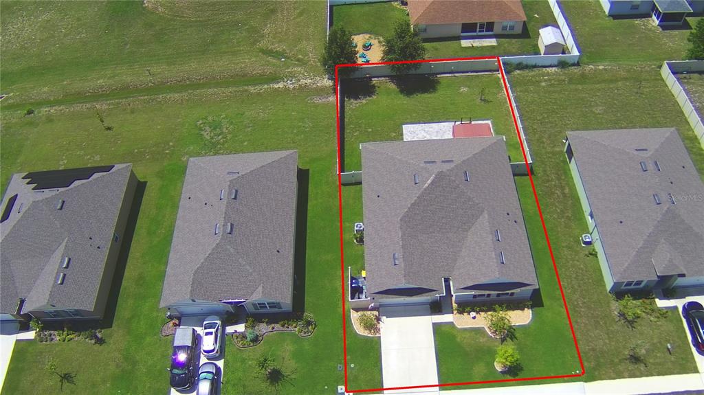 An aerial view shows a single-family house with a fenced backyard and a concrete driveway — 803 AUBURN GROVE COURT, AUBURNDALE, FL
