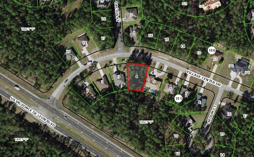 This is an aerial map showing a vacant lot highlighted in red on a residential street — 57 VILLAGE CENTER DRIVE, HOMOSASSA, FL