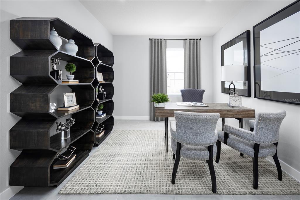 A home office features a unique dark wood honeycomb bookshelf, a desk, and two chairs — 22174 PINE GROVE LOOP, LEESBURG, FL