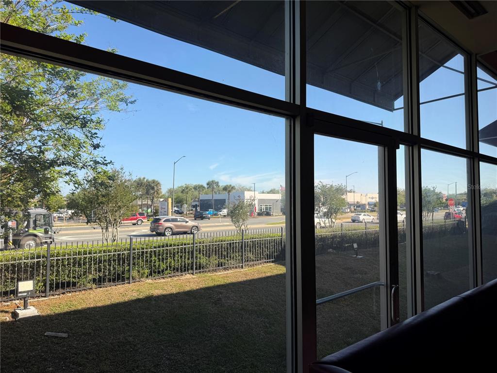A view from inside a building looking out through large windows at a parking lot — TBA SW ARCHER ROAD UNIT D, GAINESVILLE, FL