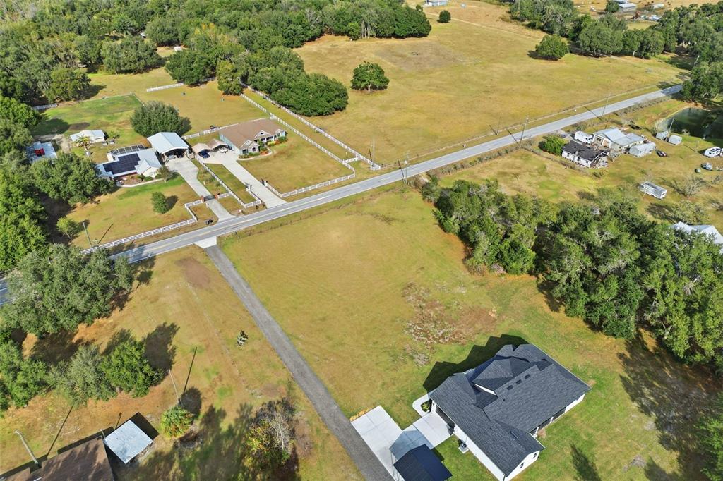 An aerial view shows a rural property with houses, outbuildings, and a road — SOCRUM LOOP ROAD W, LAKELAND, FL