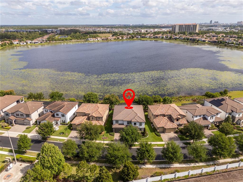 An aerial view shows a suburban house with a red location pin near a lake — 11142 LEMON LAKE BOULEVARD, ORLANDO, FL
