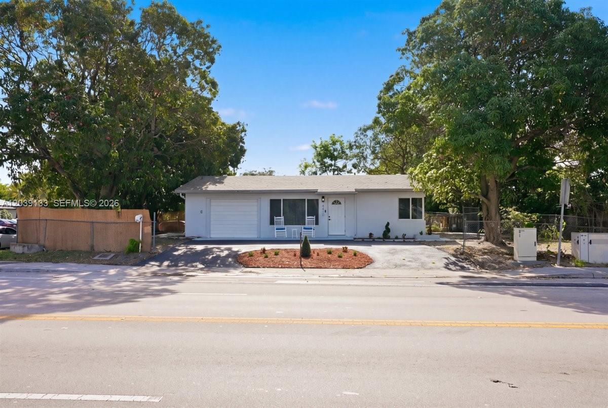 A single-story house with a white exterior, a garage, and a front yard with trees — 4410 NE 3rd Ave, Deerfield Beach FL 33064, DEERFIELD BEACH, FL