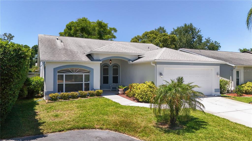 A single-story house with a white stucco exterior, a two-car garage, and a front lawn — 13109 DOBREE PLACE UNIT 29, RIVERVIEW, FL