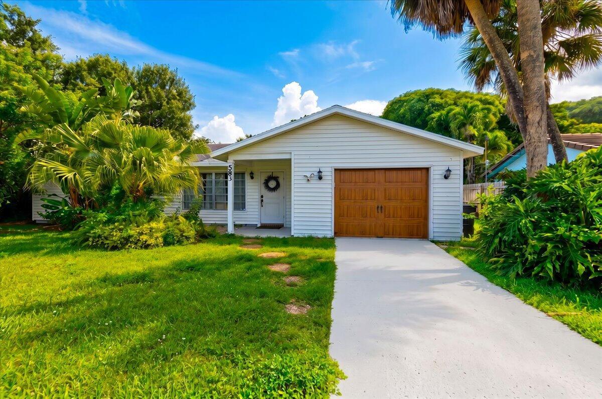 A single-story white house with a brown garage door and a palm tree-filled front yard — 583 NW 12th Terrace, Boca Raton FL 33486, BOCA RATON, FL