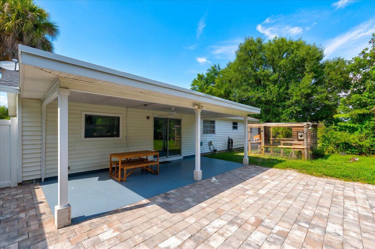 A covered patio with a painted floor and a brick paver area in a backyard — 583 NW 12th Terrace, Boca Raton FL 33486, BOCA RATON, FL
