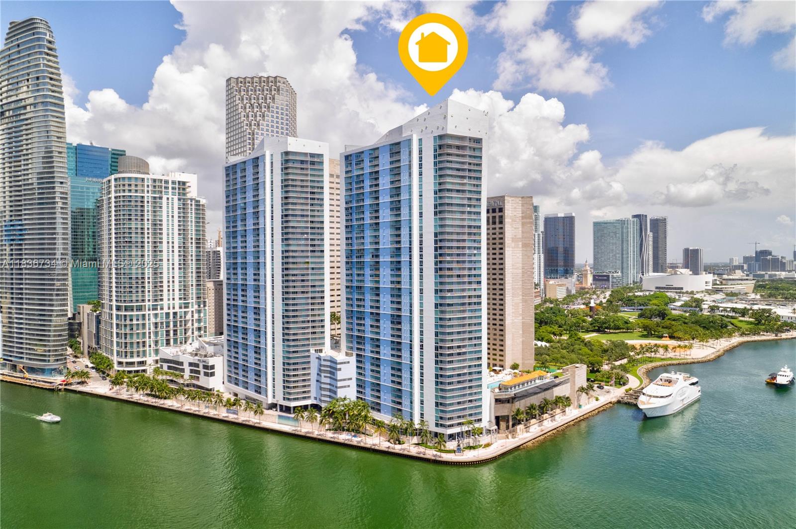 An aerial view shows high-rise residential towers situated along a waterfront in a city — 335 S Biscayne Blvd # 3108, Miami FL 33131, MIAMI, FL