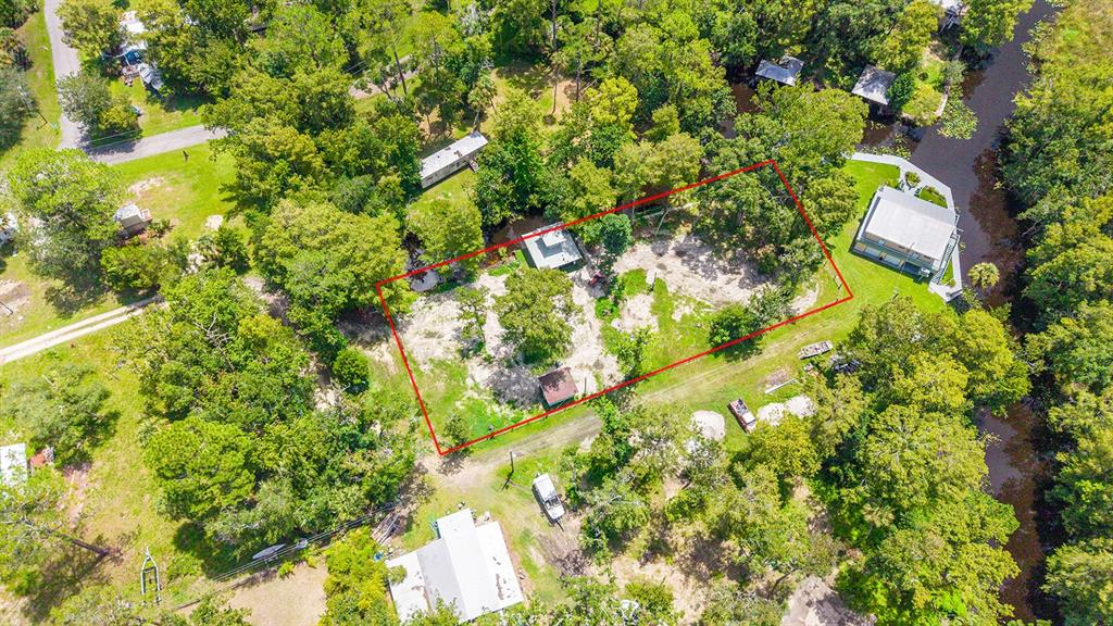 An aerial view shows a rectangular plot of land outlined in red near a waterway — 000 SE 376TH STREET, SUWANNEE, FL
