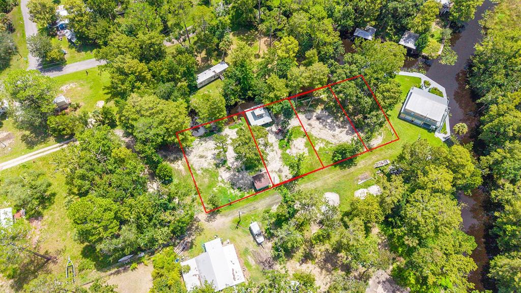 An aerial view shows a rectangular plot of land outlined in red near a waterway — 000 SE 376TH STREET, SUWANNEE, FL
