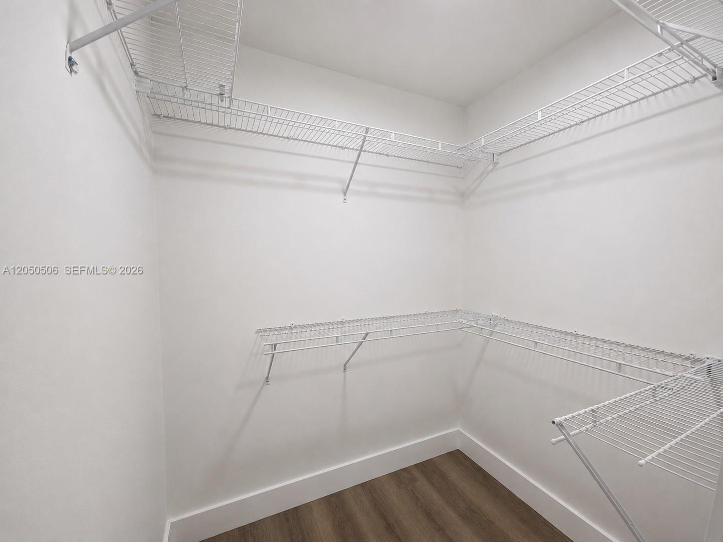 A walk-in closet features white wire shelving and wood-look flooring — 5190 E 1st Ave # B, Hialeah FL 33013, HIALEAH, FL