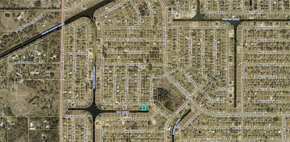 This is an aerial map showing a residential neighborhood with a highlighted property lot — 1104 NE 34TH LANE, CAPE CORAL, FL