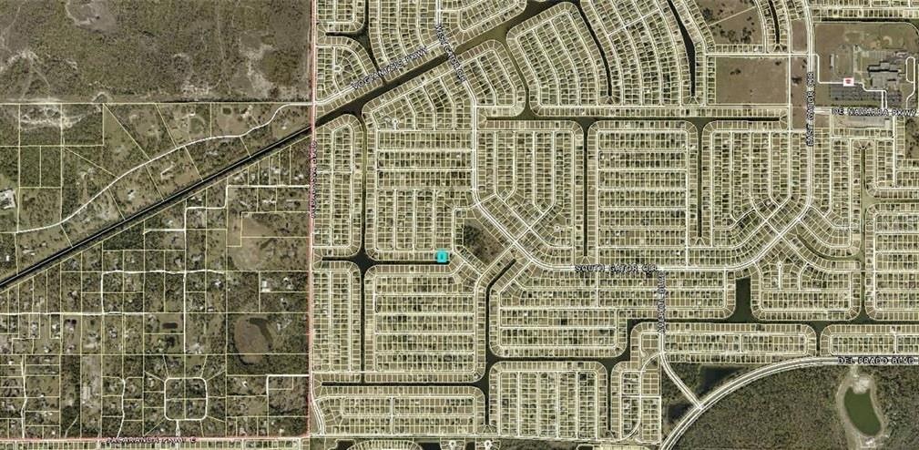 This is an aerial map view of a residential neighborhood with a highlighted property lot — 1104 NE 34TH LANE, CAPE CORAL, FL