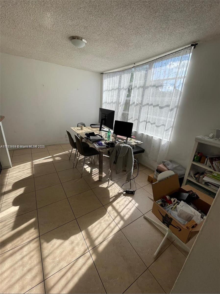A sunlit room features tiled floors, a desk with computer monitors, and a white bookshelf — 9460 Live Oak Pl # 309, Davie FL 33324, DAVIE, FL