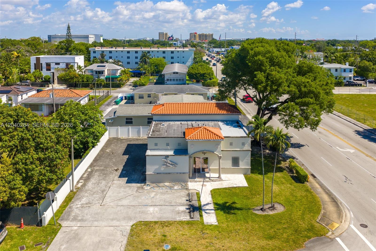An aerial view shows a commercial building with a tiled roof and a paved parking lot — 4201 SW 11th St, Miami FL 33134, MIAMI, FL