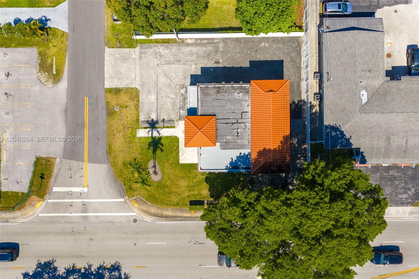 An aerial view shows a building with an orange tile roof and adjacent parking lot — 4201 SW 11th St, Miami FL 33134, MIAMI, FL