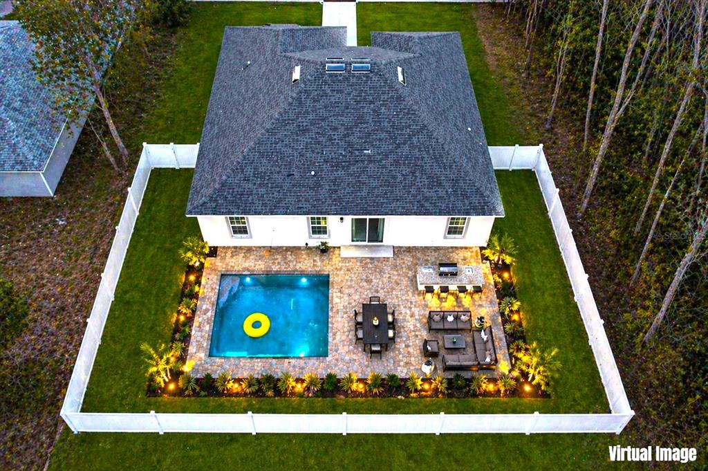 This virtual image shows a backyard with a pool, patio, and outdoor kitchen — 8839 N JOANN DRIVE, CITRUS SPRINGS, FL