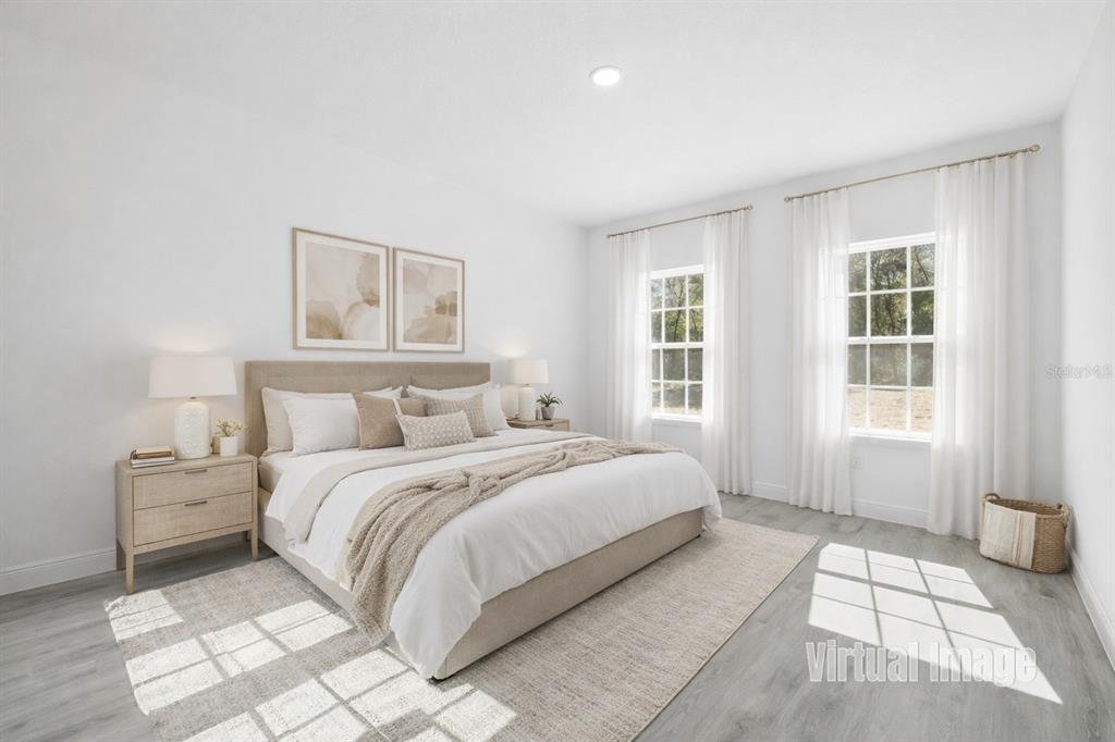 This virtual image shows a bright bedroom with a king bed, nightstands, and two windows — 8839 N JOANN DRIVE, CITRUS SPRINGS, FL