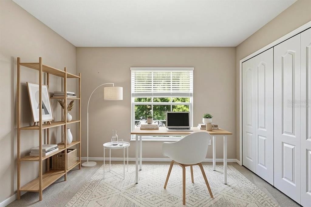 A home office features a wooden desk, a bookshelf, a white chair, and a window — 18318 HOLLAND HOUSE LOOP, LAND O LAKES, FL