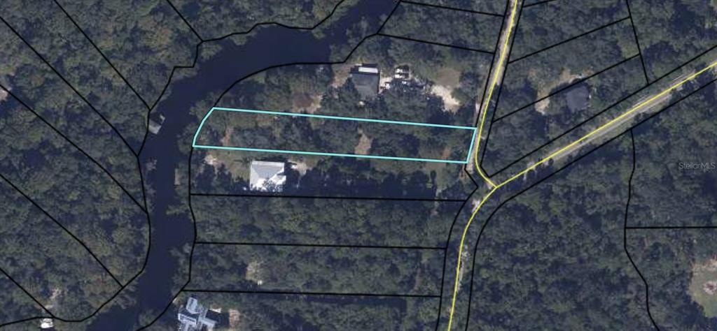 This aerial map shows a rectangular parcel of land highlighted in blue near a waterway — 2905 CREEK STREET, MIDDLEBURG, FL