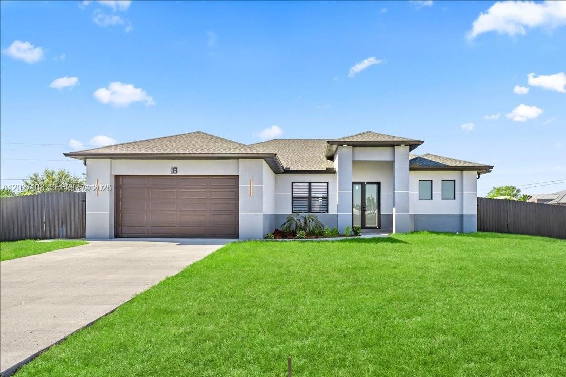 A single-story house with a brown garage door, gray stucco walls, and a green lawn — 1226 NE 5TH PL, Cape Coral FL 33909, CAPE CORAL, FL