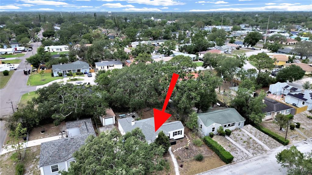 An aerial view shows a single-story house with a grey roof and a red arrow — 235 38TH STREET S, ST PETERSBURG, FL