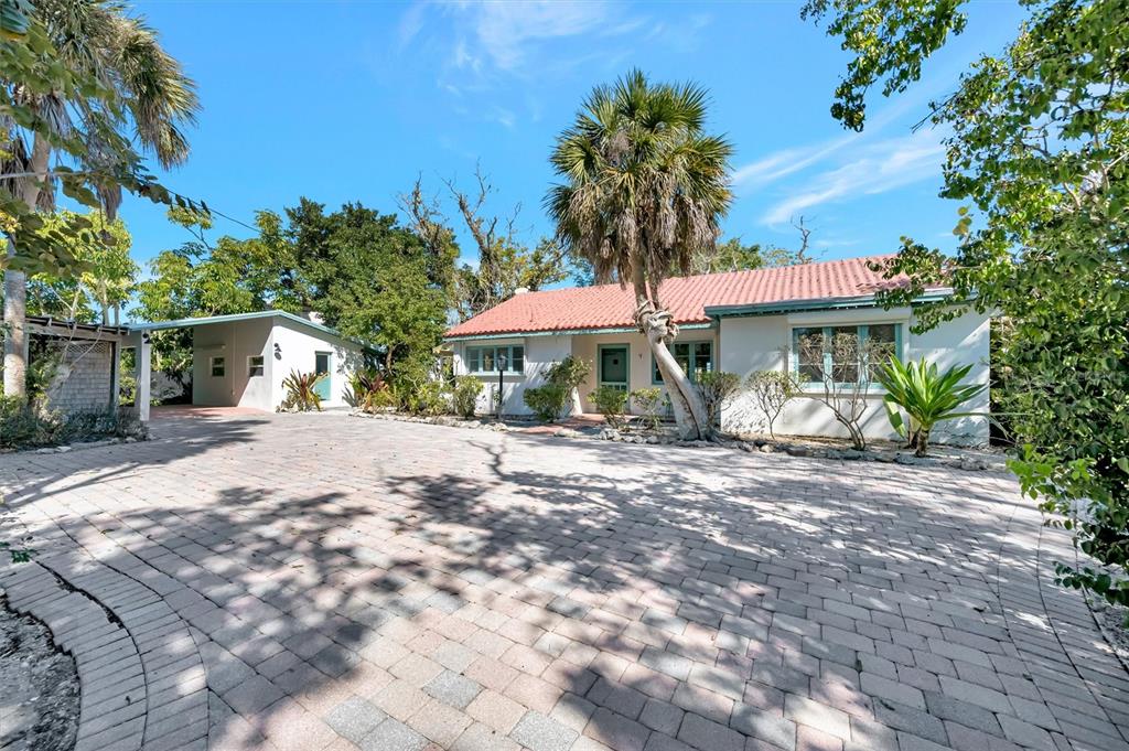A single-story house with a red tile roof and a large paved driveway — 4237 HIGEL AVENUE, SARASOTA, FL