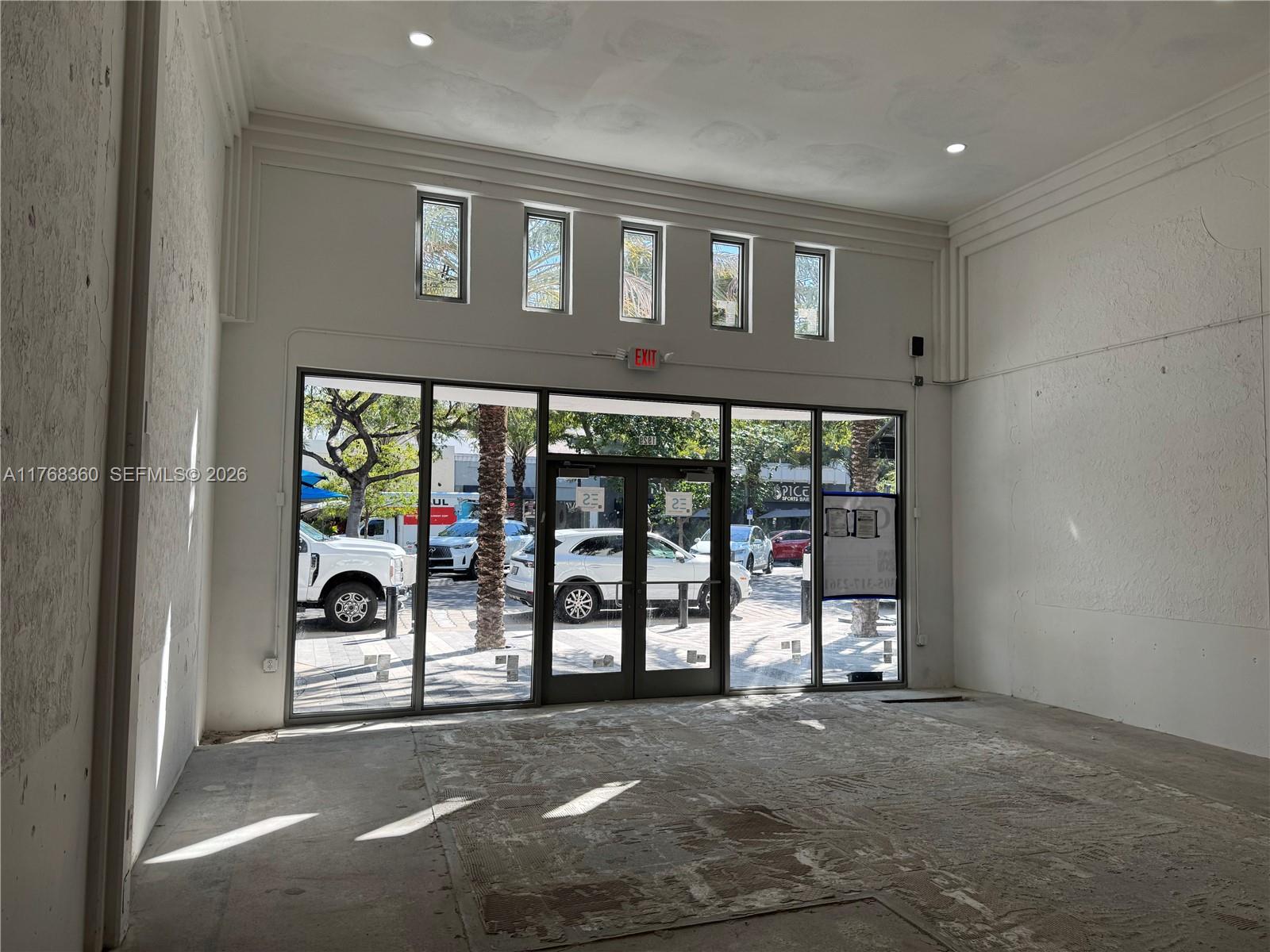 An empty commercial space features high ceilings, large glass storefront windows, and concrete flooring — 1929 Hollywood Blvd, Hollywood FL 33020, HOLLYWOOD, FL