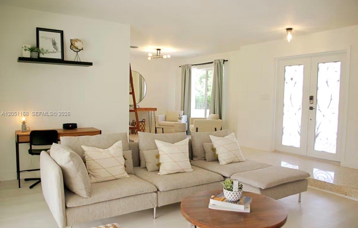 A living room features a beige sectional sofa, a round coffee table, and a desk — 29450 SW 180th Ave, Homestead FL 33030, HOMESTEAD, FL