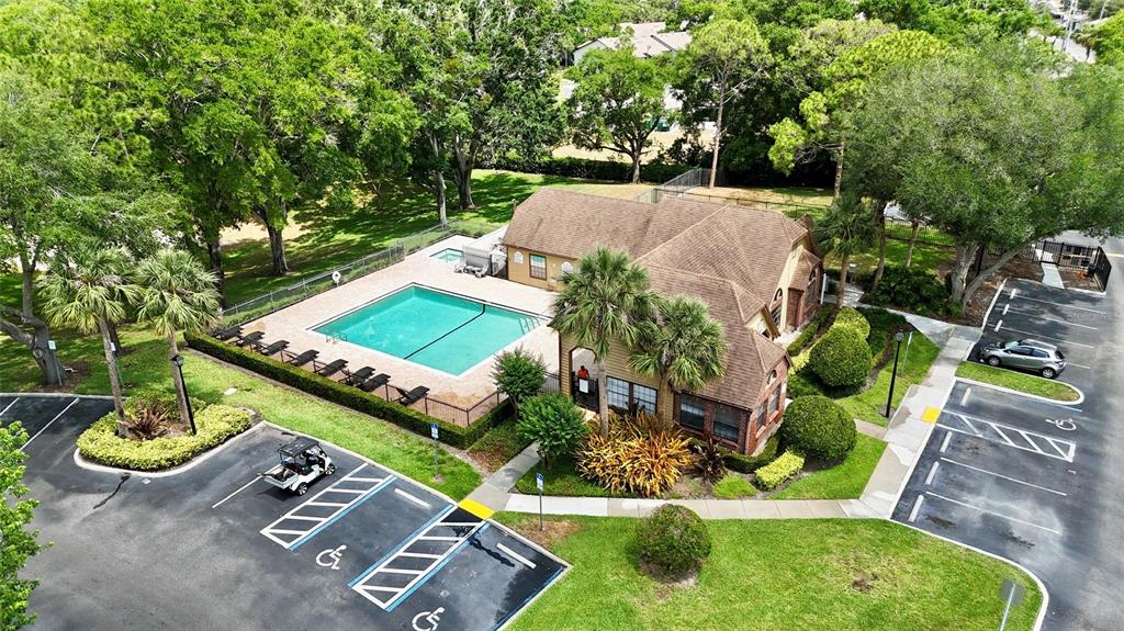 An aerial view shows a community clubhouse with a swimming pool and parking lot — 315 LAKEPOINTE DRIVE UNIT 101, ALTAMONTE SPRINGS, FL